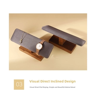 Detail of walnut wood jewelry stand with grey velvet bar for watch and bracelet