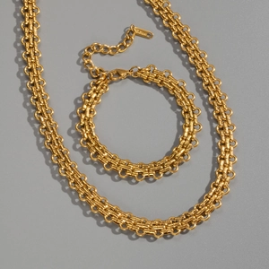 Detailed view of chunky golden stainless steel chain necklace and bracelet set