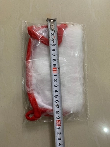 Close-up of a Santa beard mask measuring approximately 20cm with a silver tape measure