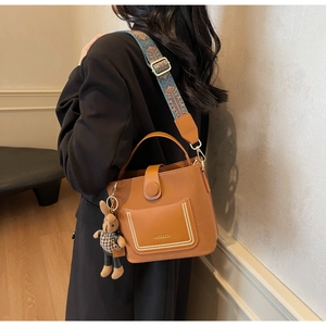 Brown PU leather crossbody bag featuring vintage jacquard strap and a rabbit plush charm