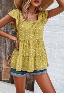 Close-up of floral mustard puff sleeve top with ruffled hem and vintage summer details