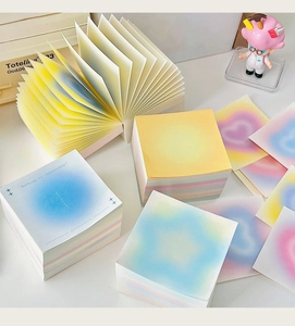 Close-up of square gradient sticky notes with soft halo colors and English quote