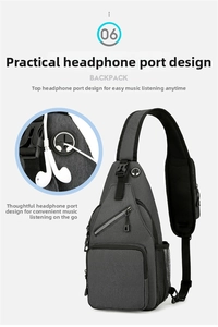 Detail view of dark grey crossbody bag with earphone port and mesh side pocket