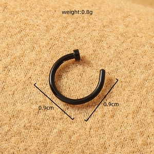 Close-up of black stainless steel U-shaped nose ring on brown felt with size specifications