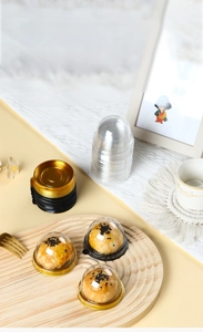 Macro detail of round plastic blister packaging for mooncakes in gold and black base