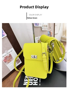 Detail view of yellow green crossgrain faux leather phone bag with silver twist lock