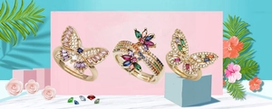 Detailed macro view of gold-plated butterfly and flower rings with colorful zircon inlay