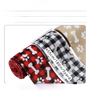 Detail showing 5 yard Christmas buffalo plaid ribbon with paw prints and wire edges