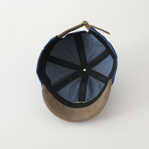 Detailed interior of blue denim kids baseball cap with adjustable brown suede strap