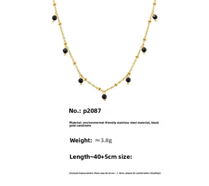 Macro shot of 18K gold plated stainless steel chain with faceted black sandstone beads