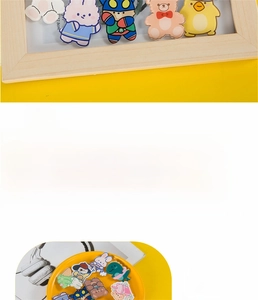 Close-up of cute acrylic cartoon pins featuring bears and bunnies on a yellow background