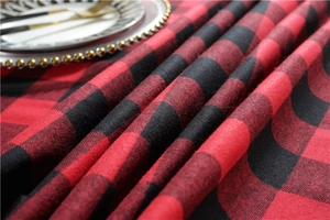 Macro view of Christmas red and black plaid tablecloth fabric texture and pattern