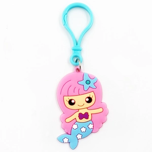 Close-up of cute cartoon mermaid keychain with pink hair and blue starfish accessory