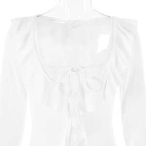 Detail of white long sleeve top featuring ruffled neckline and delicate tie-up bow