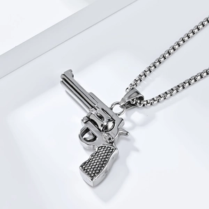 Macro shot of polished silver steel revolver pendant with a sleek box chain link necklace
