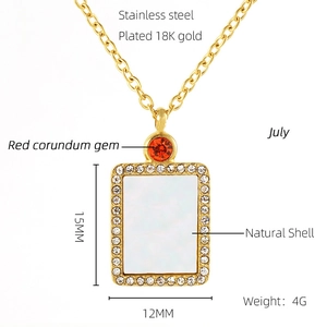 Detail showing 18K gold-plated stainless steel necklace with shell and red ruby pendant
