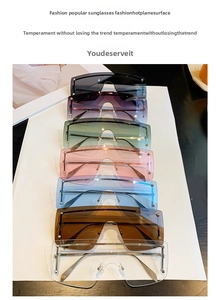 Vertical stack of oversized rimless sunglasses in seven colors with metal temples