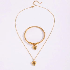 Detail of gold titanium steel jewelry set with heart pendants and romantic engraving