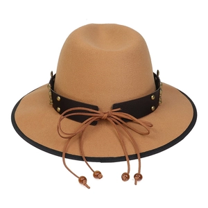 Close-up of wool fedora hat with brown leather band, brass studs, and beaded cord details