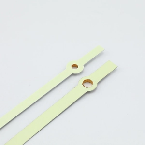 Modern minimalist luminous watch hands with gold metal mounting holes on white background