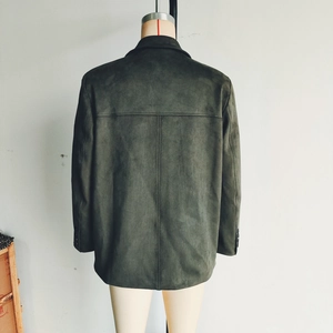 Detail view of the back seams and decorative sleeve buttons on a dark suede jacket