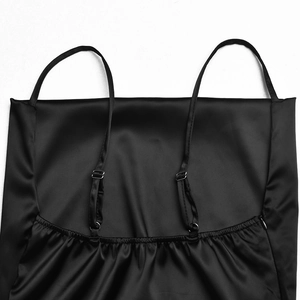 Detail of black satin dress back with adjustable thin straps and elastic ruched design