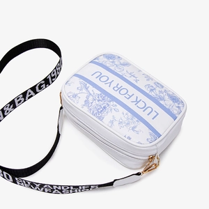 Blue and white floral printed crossbody camera bag with wide lettered shoulder strap