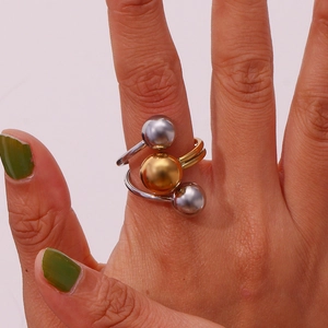 Close-up of a three-bead mixed metal adjustable ring in 18K gold and silver tones