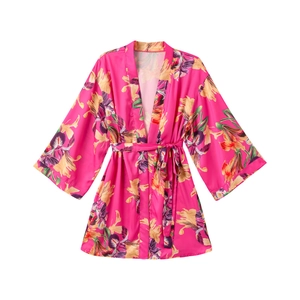 Close-up of fuchsia satin floral print robe with wide sleeves and matching waist belt
