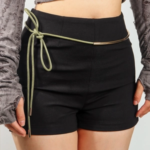 Detail of light green rope belt with gold metal tips knotted on high-waist black shorts
