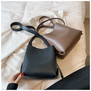 Detail view of black and brown vintage bucket bags in high-quality faux leather finish