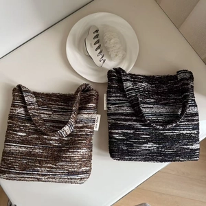 Detailed close-up of retro tweed textured knit tote bags in striped brown and black patterns