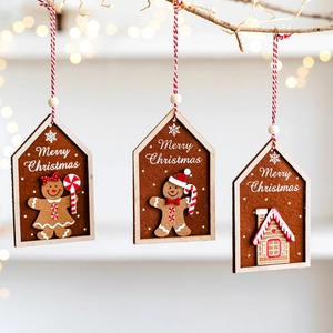 Three-piece felt gingerbread man house ornaments with Merry Christmas text on tree branches