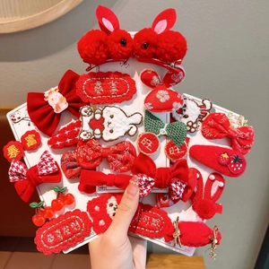 Detail of red festive plush hair clips with rabbit motifs and lucky New Year embroidery