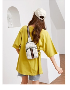 Detailed back view of a white patterned crossbody chest bag with striped shoulder strap