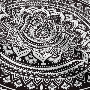 Detailed macro view of black and white mandala printed bohemian tapestry fabric texture