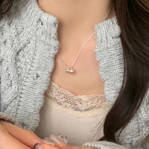 Elegant S925 silver necklace with double pearl pendants on a stylish model