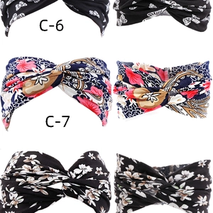 Detail of twisted fabric headbands with floral and butterfly patterns in black colors