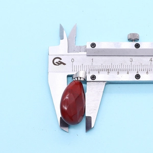 Measuring a 16x27mm faceted red gemstone teardrop pendant with a digital caliper