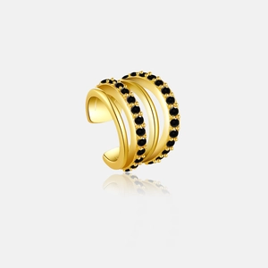 Close-up of golden multi-layered ear cuff with black gemstones and polished finish