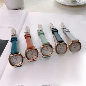 Close-up of five vintage square leather strap quartz watches in various elegant colors