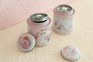 Pink tinplate tea canister featuring a Sweet Life illustration and double-lid seal
