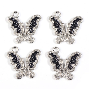 Detailed view of 4 butterfly pendants with black enamel and white rhinestones