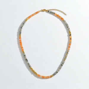 Detail of bohemian colorful beaded necklace with golden clasp and extender chain