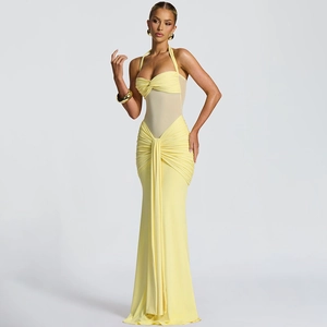 Detail of yellow halter neck dress with ruched fabric and sheer mesh paneling