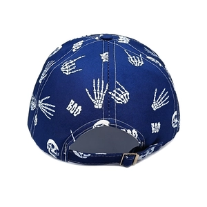 Detail of dark blue baseball cap back showing white skull hand print and metal buckle