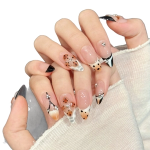 Pink leopard press-on nails with 3D bow and sparkling rhinestones on almond shape