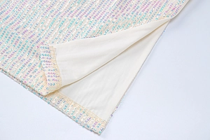 Detail of sequin mesh hem with rainbow iridescent sparkles and beige lining material