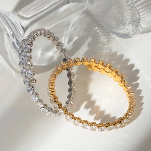 Macro shot of gold and silver plated tennis bracelets with white cubic zirconia crystals