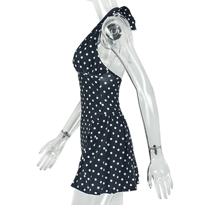 Detail of polka dot halter dress with waisted pleats on a transparent mannequin